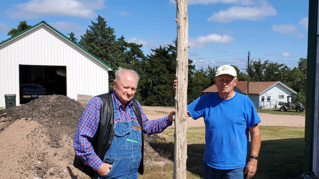 Pete Peters and Marvin Stumpf with a Flag Pole at Alkali Station